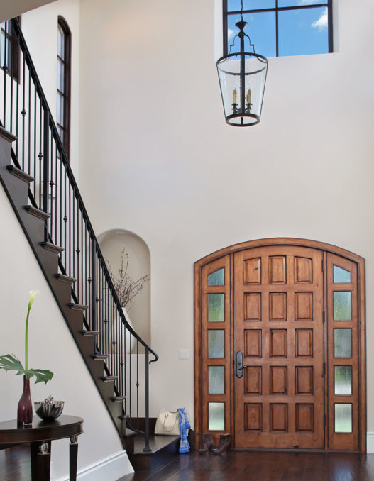 front door and staircase in mission-style Los Altos home