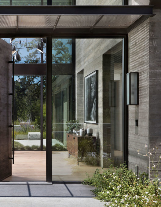 view through full-length glass door at modern farmhouse