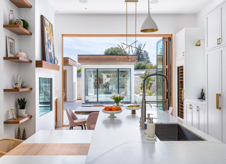 view from kitchen to pool in warm modern home